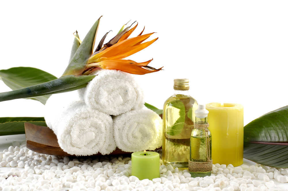 wooden,bowl,of,towel,and,spring,flower,with,massage,oil